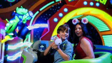 guests ride buzz lightyear space ranger spin in disney world's magic kingdom in tomorrowland area