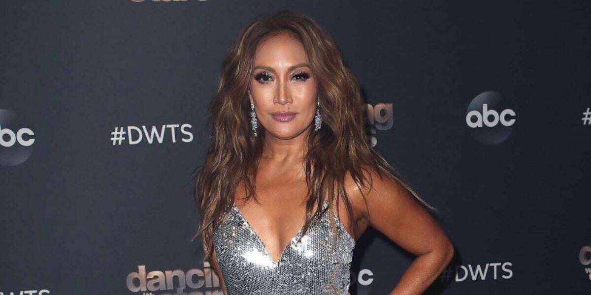 A sparkling celebrity in a silver sequin dress strikes a glamorous pose on the “Dancing with the Stars” red carpet, hand on hip and all set to dazzle fans as opening night excitement fills the ballroom before eliminations begin.
