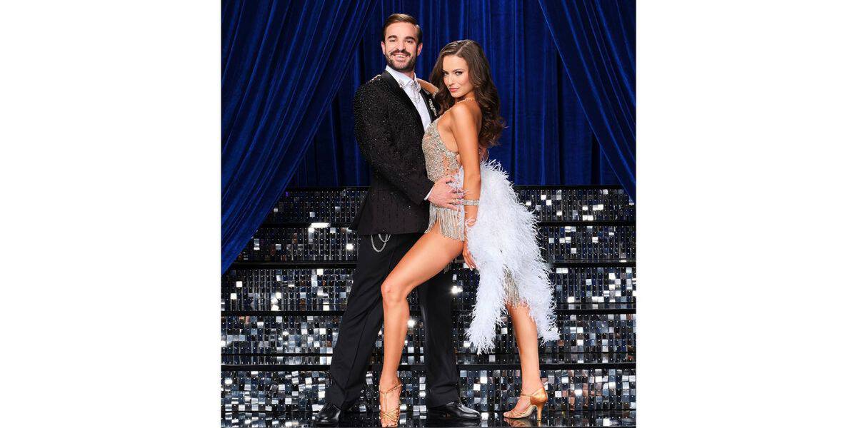A dazzling dance duo, dressed to impress in a sleek black suit and sparkling silver fringe dress, light up the Dancing With the Stars stage against shimmering blue curtains, bringing all the glitz and excitement of a live-stage spectacular that theme park guests love.