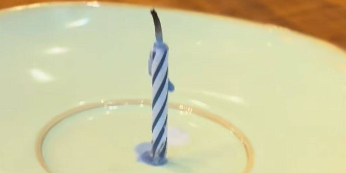A single candle on an empty plate at a Disney World restaurant