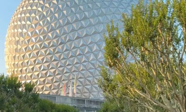 Spaceship Earth hidden behind trees inside Disney World's EPCOT theme park