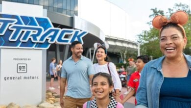 a family happily exits test track in disney world's epcot park
