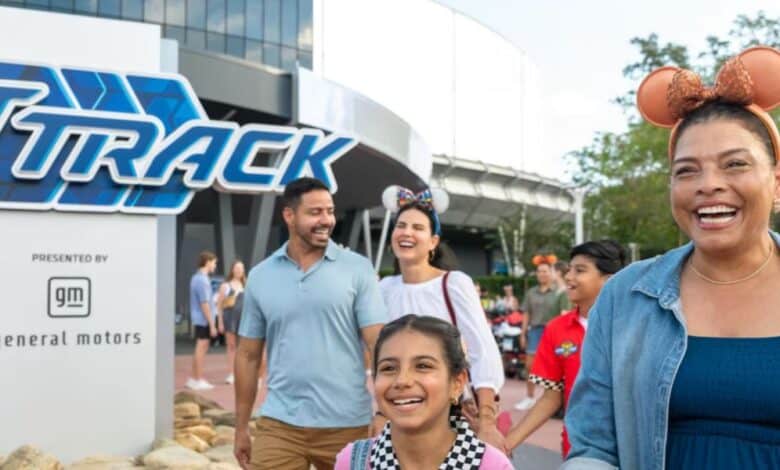 a family happily exits test track in disney world's epcot park