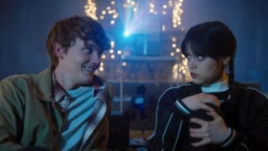 Tyler Galpin and Wednesday Addams watch a movie in 'Wednesday' Season 1 on Netflix