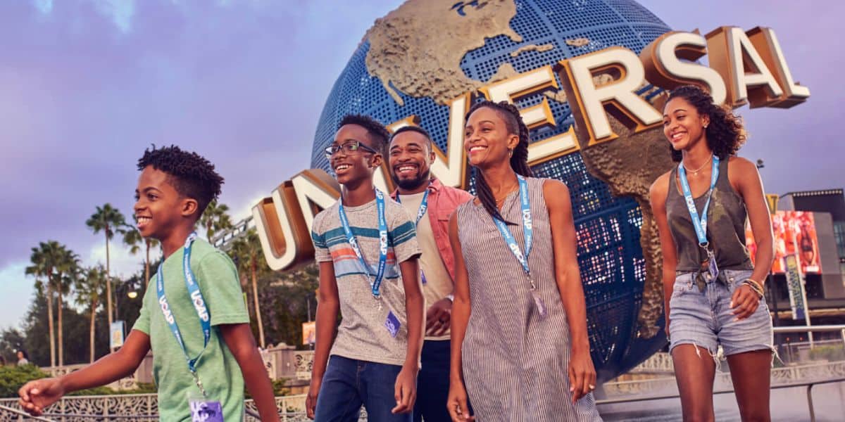 Universal Orlando family of Annual Passholders walk in front of the iconic spinning globe