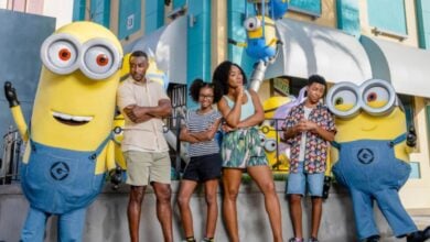 universal orlando guests pose with minions in minions land area inside of universal studios florida
