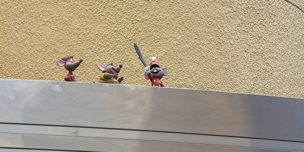 Three animated mice strike a heroic pose atop a ledge, with one wielding a needle like a sword, set against a golden, textured backdrop in the whimsical Disney Animation style—capturing the spirit of adventure you’d expect at Disneyland or Walt Disney World.