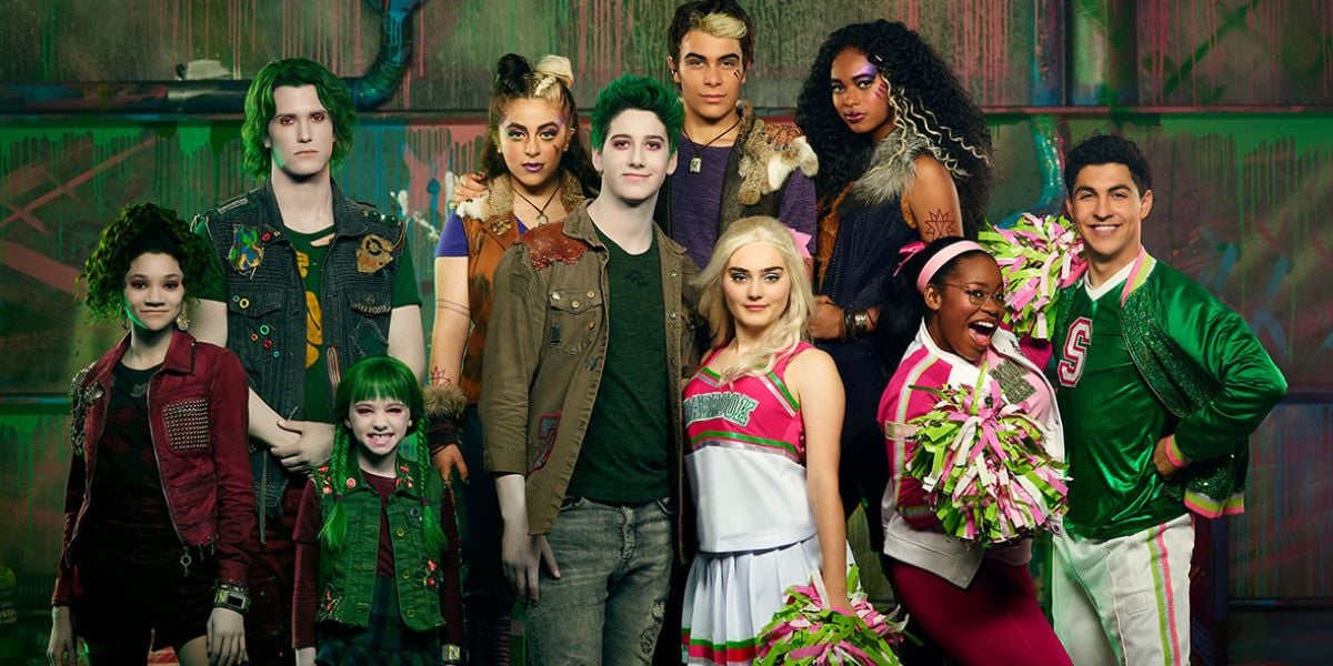 Zombies fans dressed as their favorite Seabrook characters, including teens with Bree’s signature green skin, strike a pose by a vibrant mural.