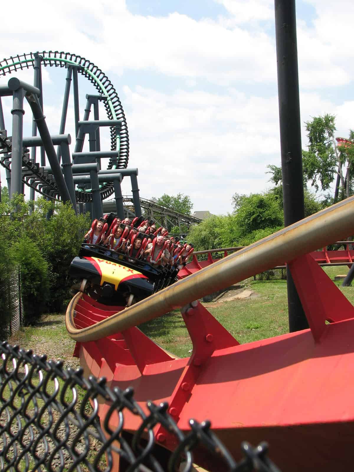 Riders rounding a curve on The Vortex at Carowinds
