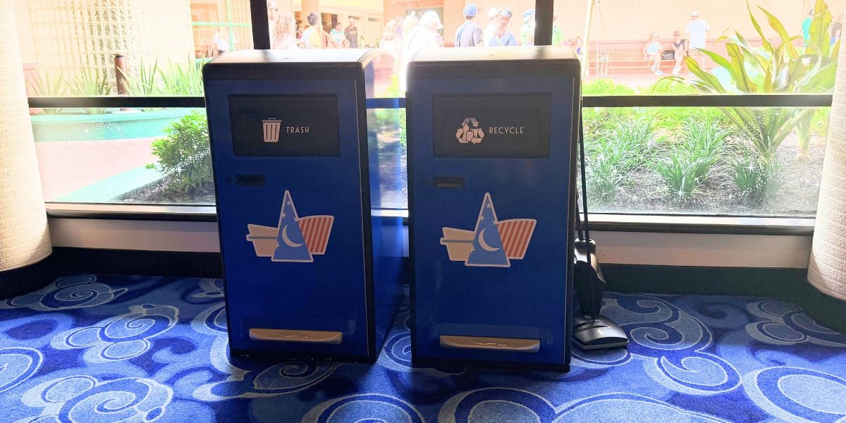Blue and solar trash cans featuring Sorcerer Mickey hat icons at Disney’s Contemporary Resort.