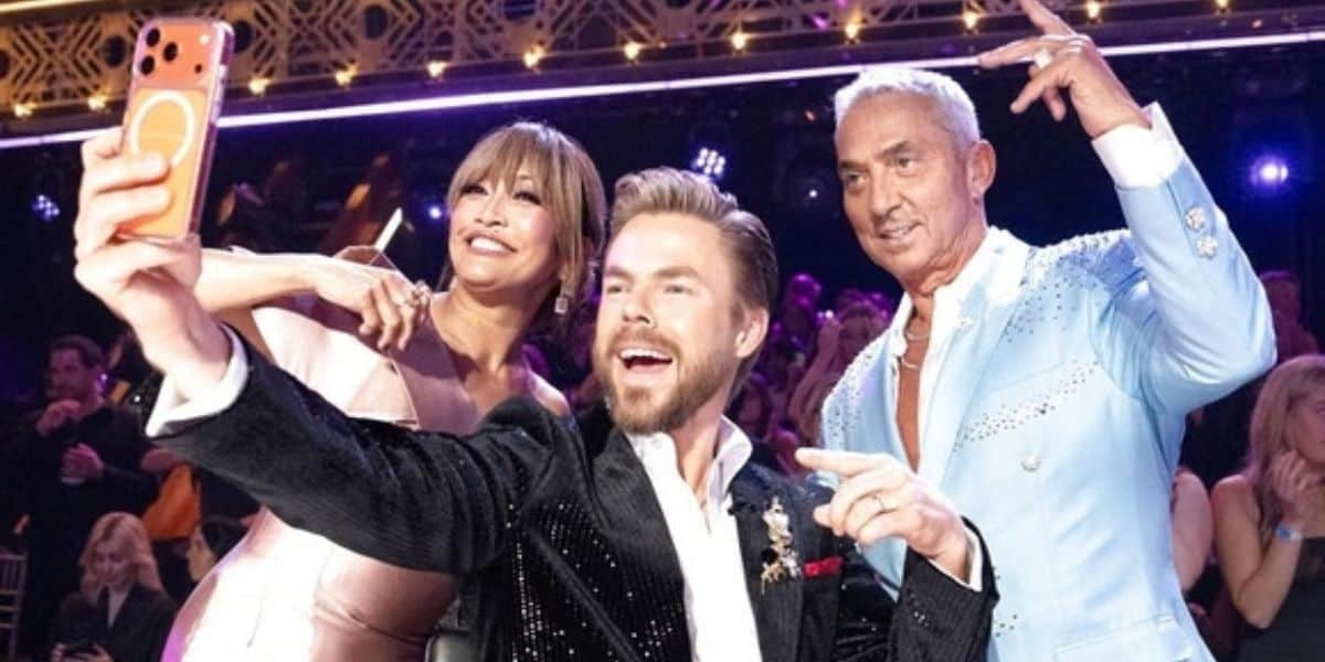 Carrie Ann Inaba, Derek Hough, and Bruno Tonioli taking a selfie on the Dancing with the Stars ballroom stage.