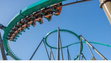 Inverted coaster train carving through a high-speed helix above a massive loop.