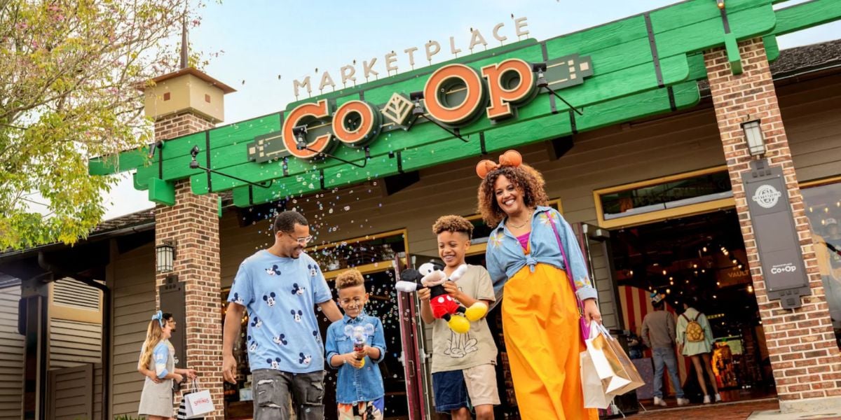 A family walking in front of the Marketplace Co-Op at Disney Springs.