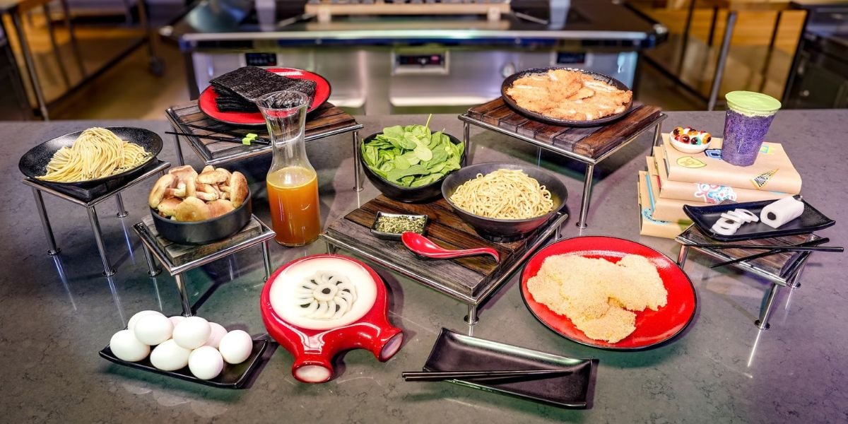 DIY ramen ingredients including noodles, broth, pork, and toppings at Monstropolis.