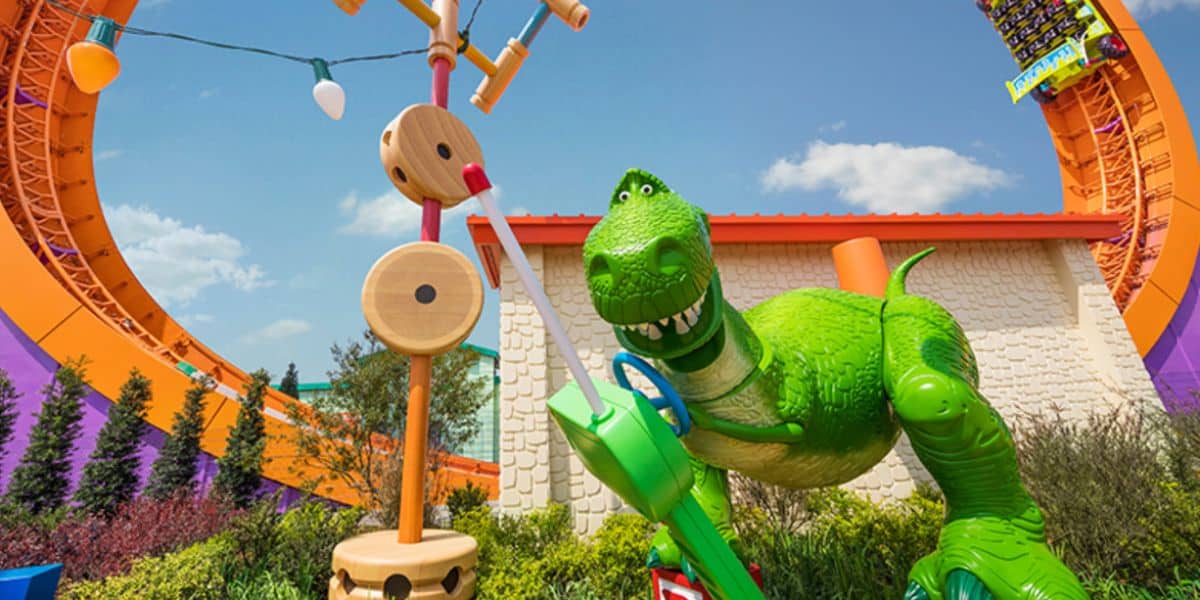 Rex statue plays with a toy controller in Toy Story Land