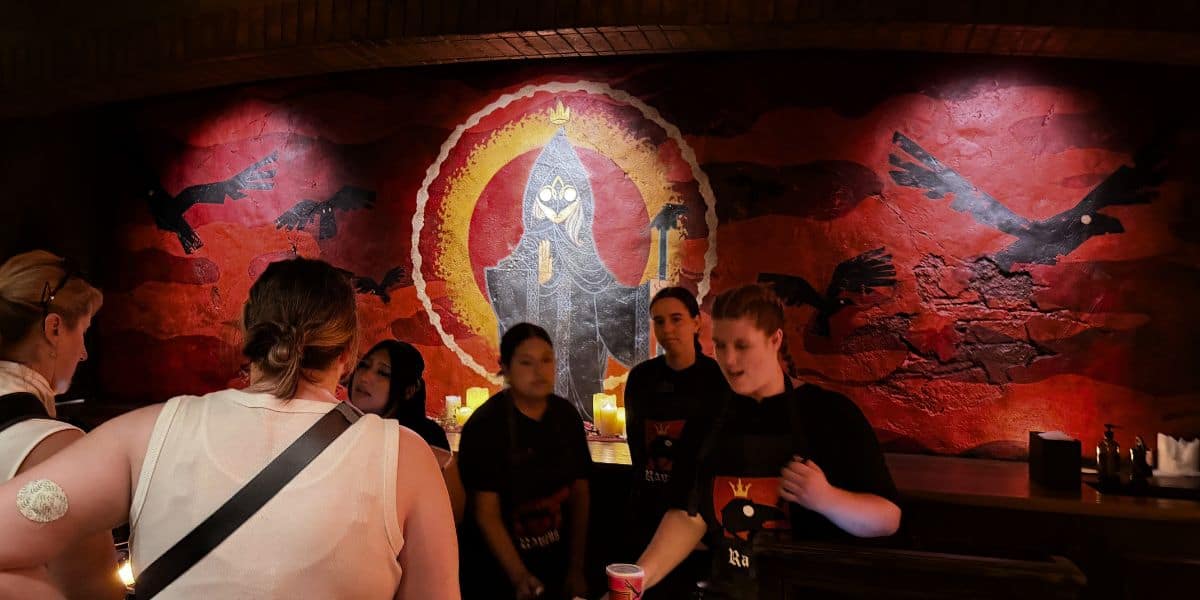 Staff at the Raven’s Hood tavern in front of the mural.