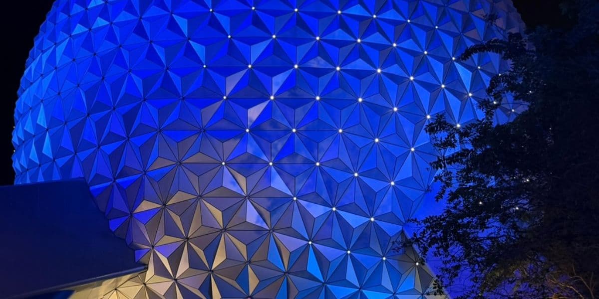 close-up of glowing blue spaceship earth at night in epcot