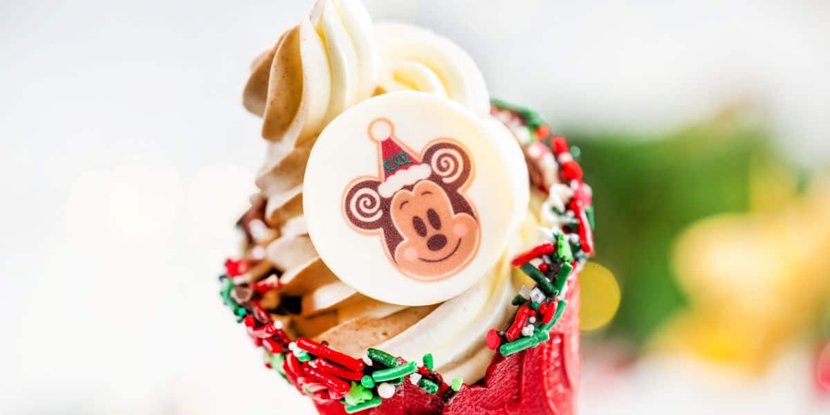 Mickey Mouse holiday treat cupcake with a festive chocolate topper and red sprinkles, available at Disney Parks.