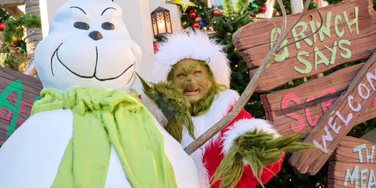 The Grinch poses with a snowman at universal studios hollywood during holidays